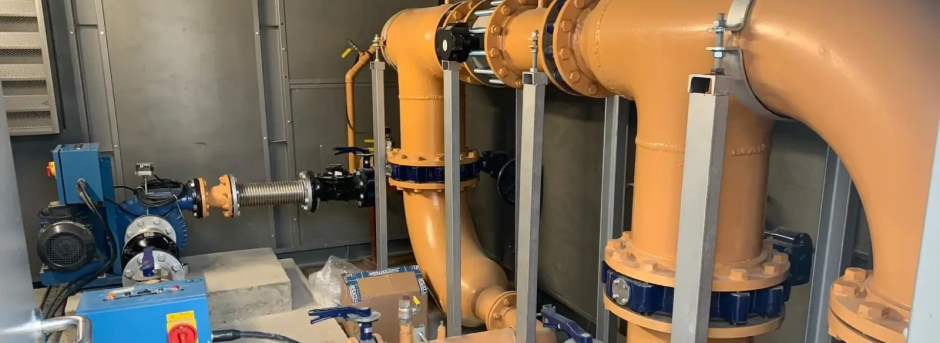 Gaswork large yellow pipes in industrial setting.