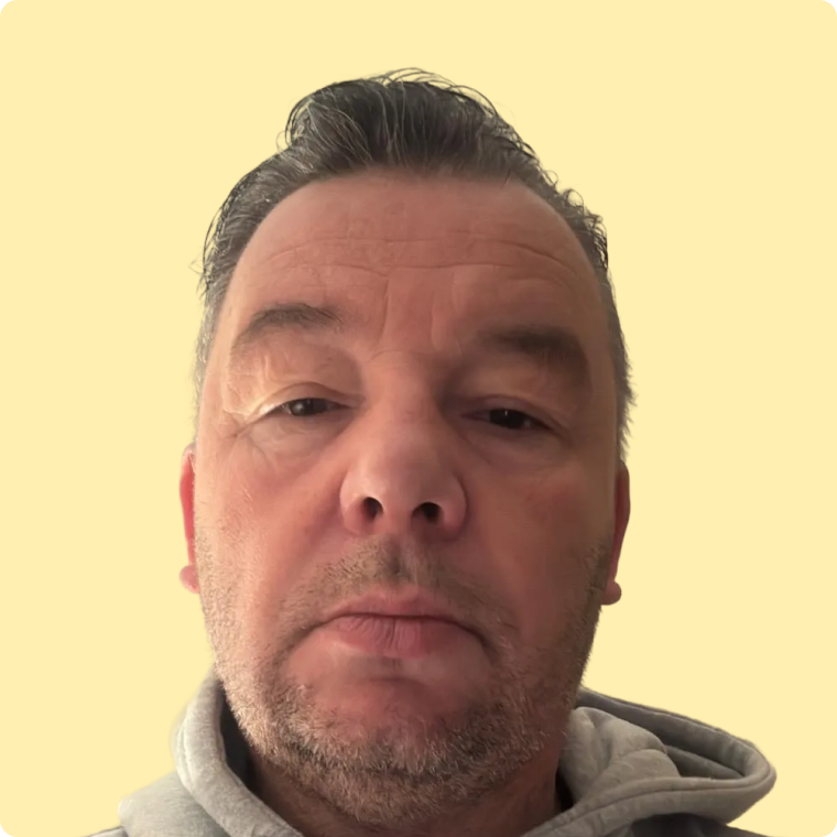 Andy, a white male, with grey hoodie, looking at the camera.