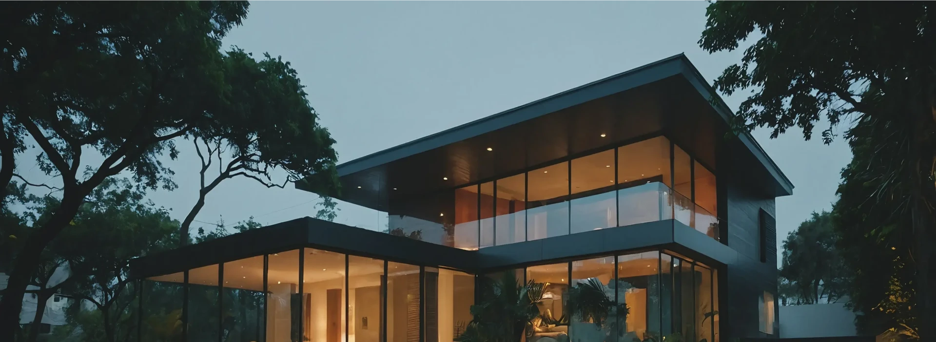 A stunning smart home with modern angular architecture style surrounded by green trees.