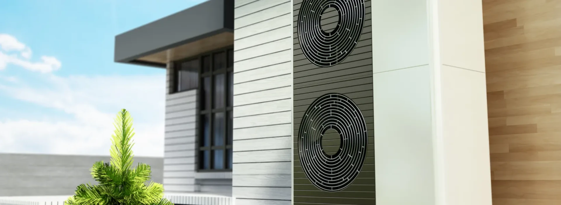 Residential heatpump on the side of a smart modern home with wooden panelling, and small shrubs.